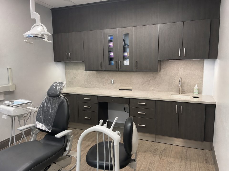 Dental operatory casework with a sterilization run, upper storage, and an integrated sink